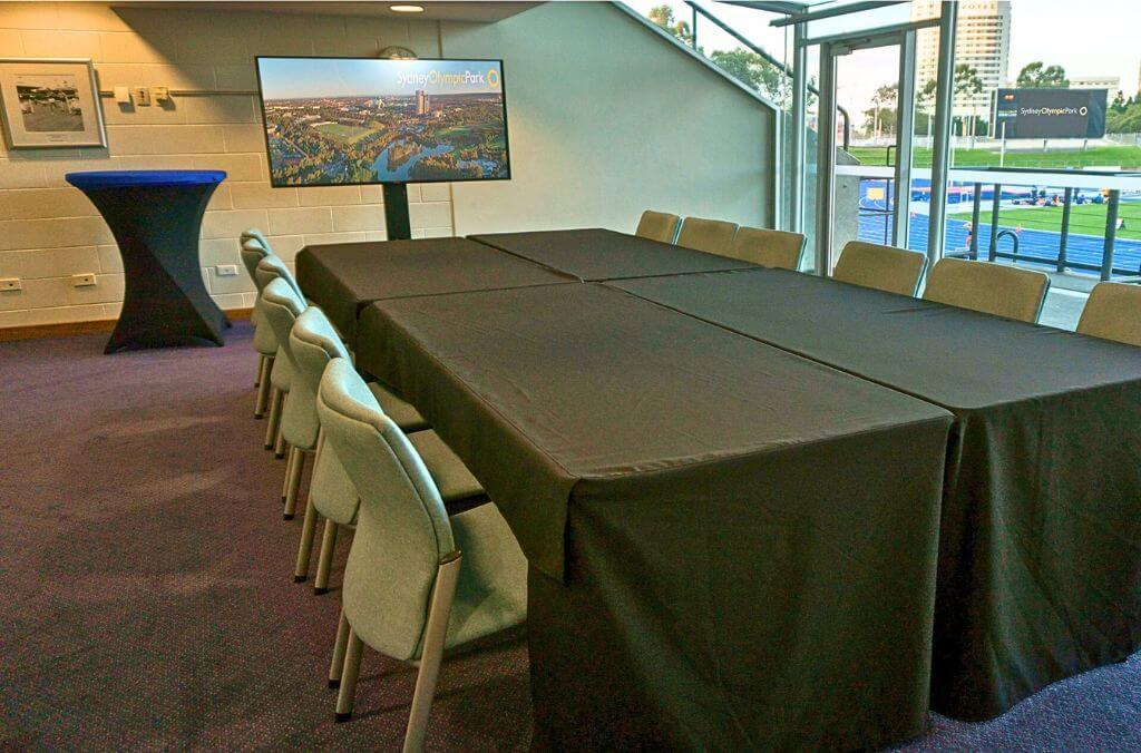 Boardroom with table and chairs, overlooking the Athletic Centre blue athletic pitch