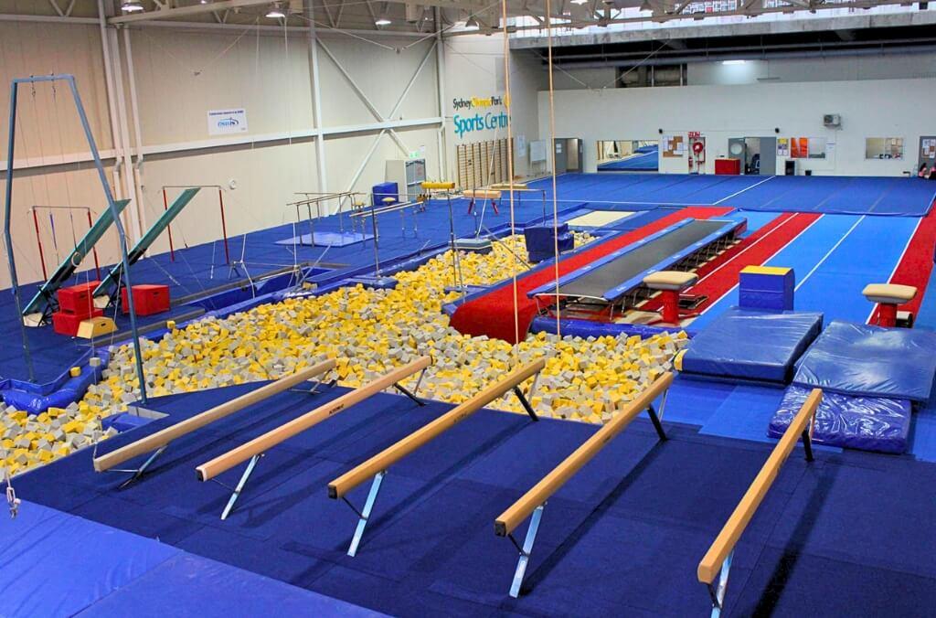 Gymnastics arena, with balance beams, a foam pit, spring board and parallel bars