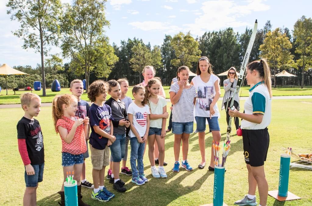 Kids listening the archery centre instructor